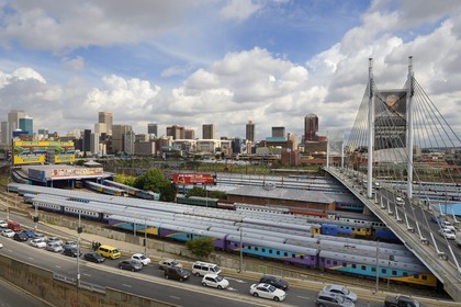 South Africa, Gauteng Province, Johannesburg, Nelson Mandela bridge over train carriages at Park Station and Johannesburg CBD (Central Business District) seen from the district of Braamfontein