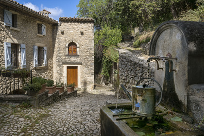 France, Drome, regional natural park of Baronnies provencales, Montbrun les Bains, labeled the Most Beautiful Villages of France, fountain on the square in front of the church