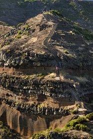 Portugal, Madeira Island, hiker on the Vereda do Areeiro hike between Pico Ruivo (1862m) and Pico Arieiro (1817m), at the foot of Pico Arieiro