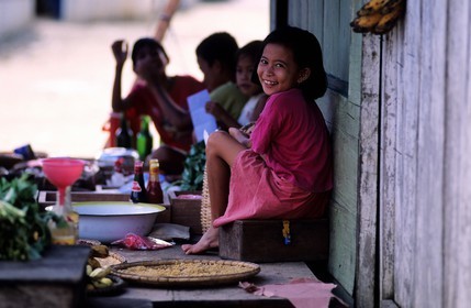 Indonesia, Sulawesi, young children eating in the Togian Islands