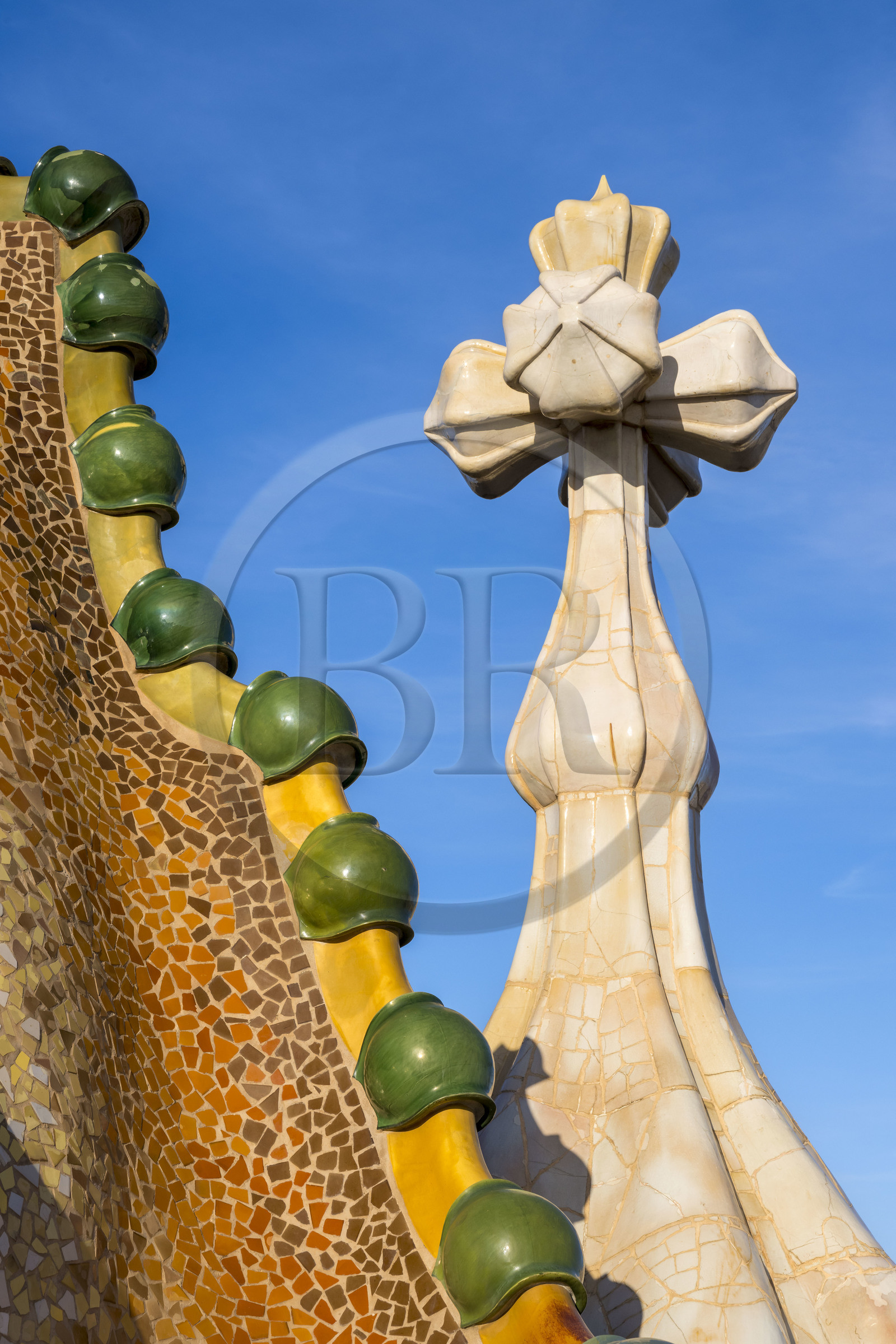 Spain, Catalonia, Barcelona, Eixample district, Passeig de Gracia, Casa Batllo by Catalan modernist architect Antoni Gaudi, UNESCO World Heritage site, roof suggesting the spine of the dragon and tower crowned with a ceramic spire topped with a typical Gaudi cross