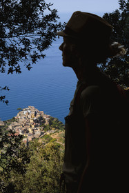 Italy, Liguria, Cinque Terre National Park listed as World Heritage by UNESCO, hikers climbing on the GR 586 path between Corniglia and Volastra above Manarola, the village of Corniglia in the background