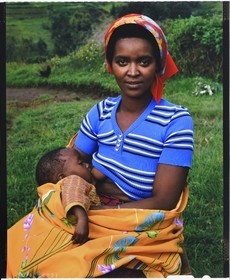 Burundi, Bujumbura Province, Ijenda area, Tutsi woman breastfeeding her baby (4x5 reversal film reproduction)