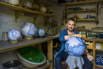 France, Charente, Cognac, Gabriel Gaborel, creator of OrbisTerrae, manufactures handcrafted terrestrial globes painted in watercolor