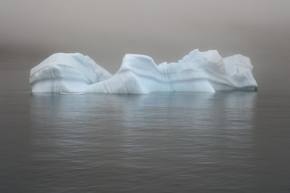Greenland, west coast, Disko Island, iceberg in the mist off Qeqertarsuaq