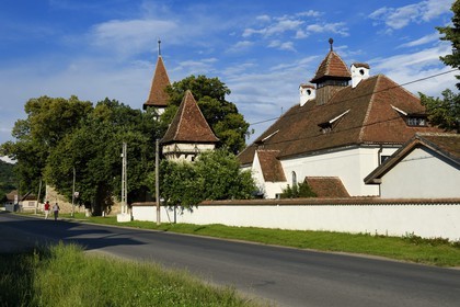 Romania, Transylvania, Cincsor, the village school and the 13th century fortified church in the background
