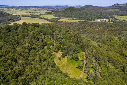 France, Puy de Dome, Aydat,  Parc Naturel Régional des Volcans d'Auvergne (regional nature park of Auvergne volcanoes), the Puy de Vichatel volcano, the Maison du Parc at the Chateau de Montlosier in the background on the right (aerial view)