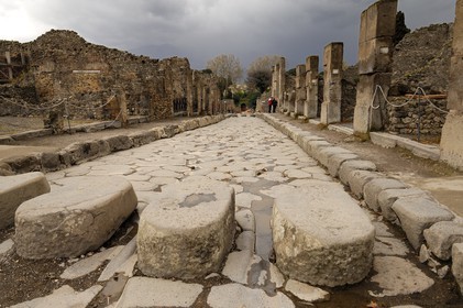 Italy, Campania, Pompei, archeological site listed as World Heritage by UNESCO, old paved street of the city, pedestrian crossing