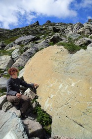France, Alpes-Maritimes, parc national du Mercantour (Mercantour National Park), the Vallee des Merveilles (Valley of Wonders) scattered with thousands of rupestral engravings of the Bronze Age, the archaeologist Nicoletta Bianchi studies the Roche de l’Eclat engraved with hornlike figures, daggers and a large checkerboard-like figure that could symbolize cultivated fields