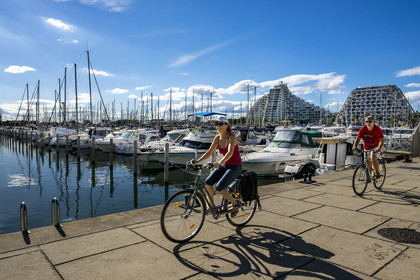 France, Herault, La Grande-Motte, labeled 20th century heritage, the port, the building La Grande Pyramide on the left and the Residence L'Eden on the right in the background