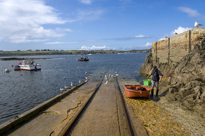 France, Finistère, Iroise Sea, Ouessant Island, the port of Lampaul in Lampaul bay, the Feunteun Velen peninsula in the background