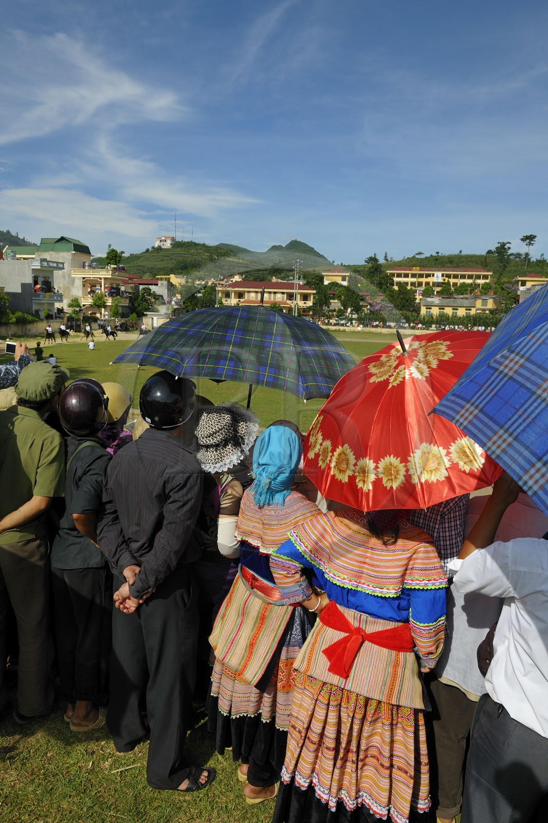 Vietnam, Lao Cai province, Bac Ha, annual race of horses and two women from the Flower Hmong minority in foreground