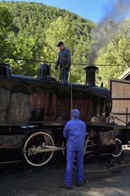 France, Alpes-Maritimes, Puget Theniers, the Train des Pignes historic train, engineer and stoker make water for the locomotive