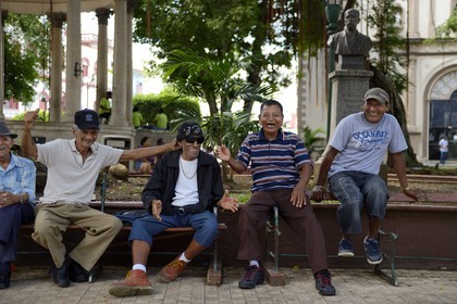 Panama, Panama City, Santa Ana neighborhood, group of men talking and laughing in park Santa Ana