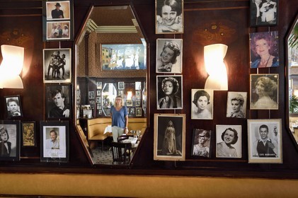 France, Allier (03), Vichy, Brasserie du Casino et des Artistes restaurant with Art Deco decor, Delphine Tajetti reflected between the photos of the artists who came to dine at the restaurant