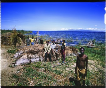 Burundi, Rumonge Province, group of fishermen on Lake Tanganyika, fishermen are exclusively Hutu and come down from the  hills to settle in temporary huts for at least 6 months, fishing is generally done at night with lampara and it's mainly ndagalas (fried fish) mukekes and Lates niloticus (4x5 reversal film reproduction)