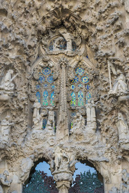 Spain, Catalonia, Barcelona, Eixample district, Sagrada Familia basilica by Catalan modernist architect Antoni Gaudi, listed as a UNESCO World Heritage Site, facade of the Nativity, the Charity Gate, the mother of God and Saint Joseph with Jesus just born