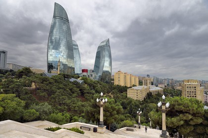 Azerbaijan, Baku, Flame Towers by architects Hellmuth, Obata & Kassabaum and the Shehidler Mosque at his feet, staircase that leads to the Martyrs Memorial in the foreground