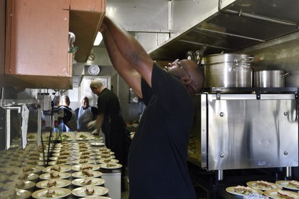 Namibia, Erongo region, the Shongololo express train, one of the two chefs in the narrow kitchen car