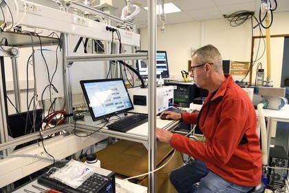 France, Puy de Dome, Parc Naturel Régional des Volcans d'Auvergne, Observation station at the top of Puy du Dôme, Jean-Luc Baray researcher at the Laboratory of Physical Meteorology (Clermont-Ferrand Earth Physics Observatory (OPGC) and Blaise Pascal University in Clermont-Ferrand), reads weather data from sensors on the roof of the institute and controls the measured meteorological and microphysical parameters (in particular the number and size of water drops)