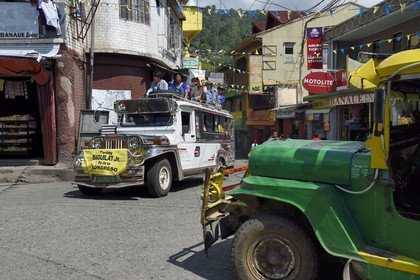 Philippines, Ifugao province, Banaue town, jeepney (elongated jeep to transport passengers) on the main square, passengers on the roof
