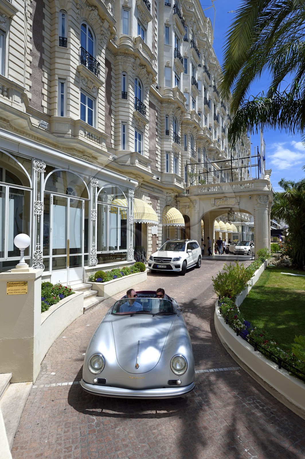 France, Alpes-Maritimes, Cannes, the Carlton palace on the boulevard de la Croisette, aboard a collection convertible Porsche Speedster 356