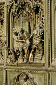 Italy, Lombardy, Milan, the Duomo in the historical center, cathedral in Gothic Flamboyant style, central portal, bronze door which tells the story of Mary's life (drawings by Ludovico Pogliaghi)