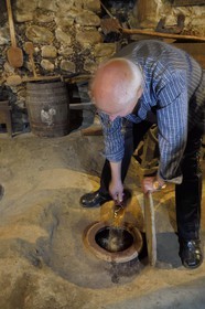Georgia, Kakheti, Gurjaani, Velistsikhe, Mr Nordari, wine producer in his cellar, the wine is aged in buried jars
