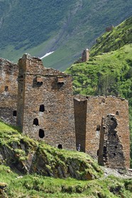 Georgia, Kakheti, Tusheti National Park, Alazani River Valley in the mountains of Pirikiti, hiker crossing a set of medieval defensive towers in the ancient village of Parsma (Baso)