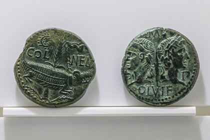 France, Gard, Nimes, Romanity museum (Musée de la Romanite), bronze coin Dupondius said As de Nimes around 10-15 AD., with on the right the profiles of Agrippa and Tiberius and on the reverse the crocodile chained to the palm