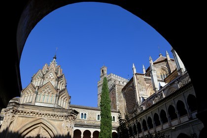 Spain, Extremadura, Guadalupe, Royal Monastery of Santa Maria de Guadalupe listed as World Heritage by UNESCO, Mudejar cloister built in the 15th century and the church in the background