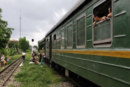 Vietnam, day train from Lao Cai to Hanoi, loading goods at a station