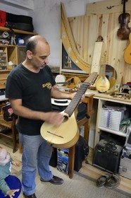 France, Haute Corse, Balagne, village of Pigna, the stringed-instrument maker Ugo Casalonga in his workshop making a cetera (cithern)