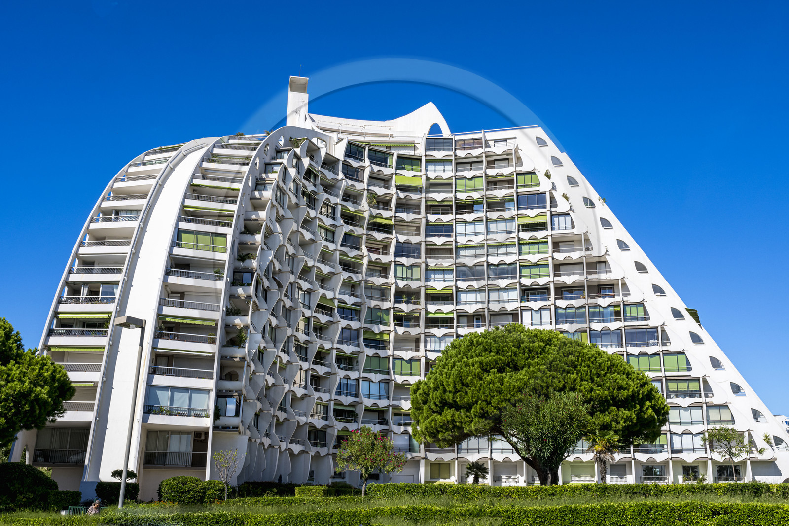 France, Herault, La Grande-Motte, labeled 20th century heritage, The Great Pyramid built in 1974 by the architects Jean Balladur and Jean-Bernard Tostivint, this flagship building for the port of the seaside resort dominates the whole city, forms a curved Y plan and houses a hotel and apartments