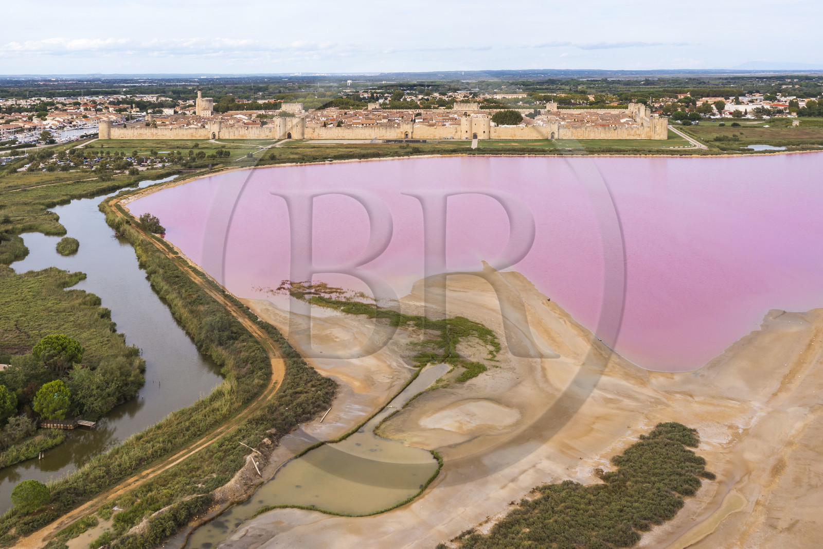 France, Gard, Aigues Mortes, the medieval town surrounded by its ramparts on the edge of the salt marshes (Salins du Midi) (aerial view)