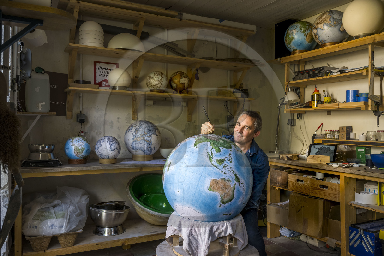 France, Charente, Cognac, Gabriel Gaborel, creator of OrbisTerrae, manufactures handcrafted terrestrial globes painted in watercolor