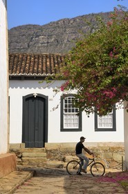 Brazil, Minas Gerais state, Tirandentes, cyclist in an alley of the old town (Gold Route, Estrada Real)