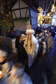 France, Haut Rhin, Eguisheim, the Christkindel with its crown of candles and the angels accompany the many children holding their lanterns for the Procession of Lights in the alleys of the town, it pays homage to Saint Lucia, one of the traditional characters of Alsatian Christmas