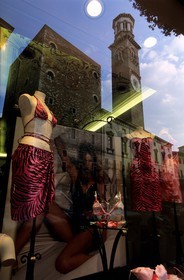 Italy, Venetia, Verona, Piazza Erbe, Lamberti Tower reflecting in a window of a shop
