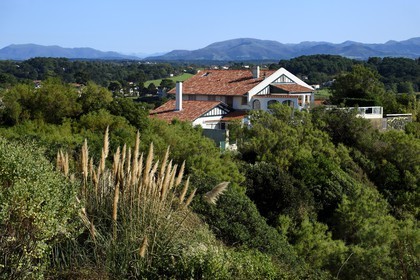 France, Pyrenees Atlantiques, Basque Country coast, Bidart, traditional neobasque style house and the Pyrenees in the background