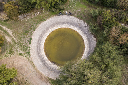 France, Aveyron, Grands-Causses Regional Nature Park, Versols et Lapeyre, Hermilix farm, a lavogne, sealed natural excavation to collect rainwater and water livestock (aerial view)