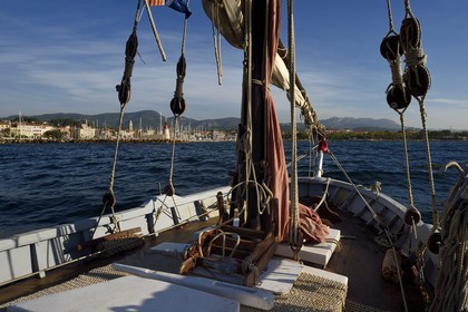 France, Var, Sanary-sur-Mer, Christian Benet who is president of the Sanary Pointus association aboard his eight-meter with Latin sail Pointu called Belle Brise