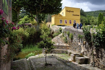 France, Var, Massif des Maures, Collobrières, the Pont Vieux (old bridge) and the Confiserie Azuréenne (handcrafted around the chestnut) in a former factory of corks