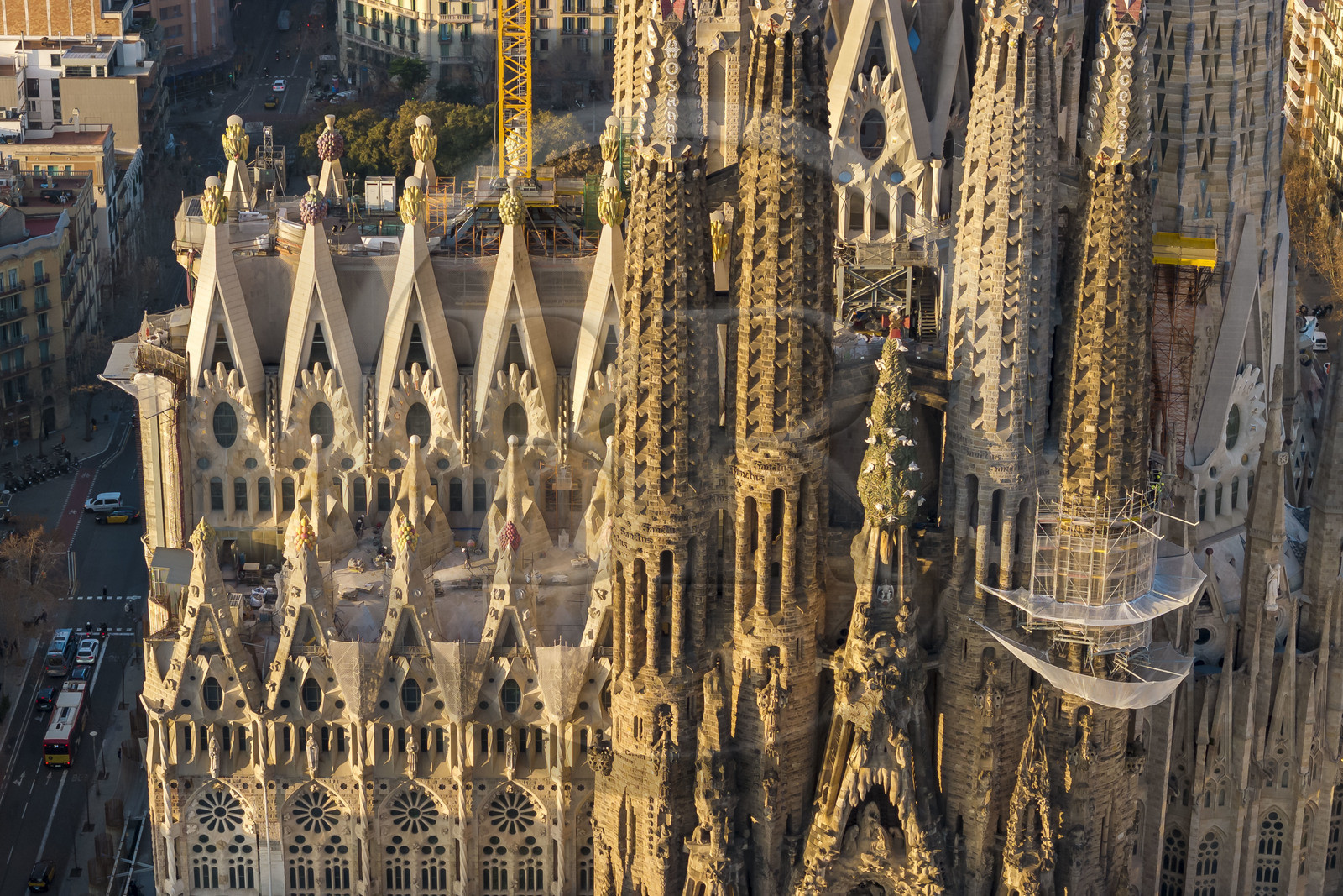 Espagne, Catalogne, Barcelone, quartier de l'Eixample, basilique de la Sagrada Familia de l'architecte du modernisme catalan Antoni Gaudi classée Patrimoine Mondial de l'UNESCO, sommets surmontés de mosaïques en forme de fruits entourant le chantier sur le toit de la nef ici côté facade de la Passion