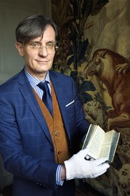 France, Aisne, Château-Thierry, Jean de La Fontaine Museum - city of Chateau-Thierry, the director of the museum pole Nicolas Rousseau holding the La Fontaine's Fables book, Claude Barbin Denys Thierry non illustrated edition, circa 1668, in-12