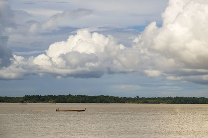 France, French Guiana, Saint-Laurent-du-Maroni, pirogue on the Maroni River, natural border with Suriname in the background