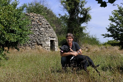 France, Gard, region of the Pays d'Uzege, Uzes, Michel Tournayre creator of the “Truffières du Soleil” on his truffle plantation with one of his truffle dog