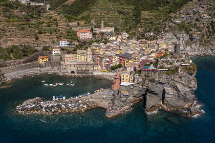 Italy, Liguria, Cinque Terre National Park listed as World Heritage by UNESCO, village of Vernazza and its port (aerial view)