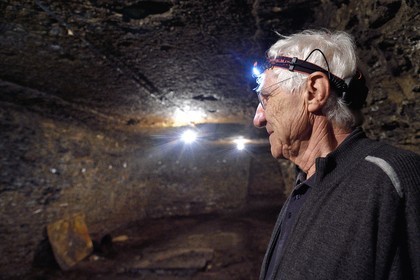 France, Puy de Dome, Clermont Ferrand, rue Pascal, Hotel Martial de Grandseigne, René Ribeyre member of the ACAVIC association (Amis des Caves du Vieux Clermont) in the tuff cellars on three levels