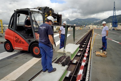 France, Var, Toulon, the naval base (Arsenal), the Charles de Gaulle nuclear-powered aircraft carrier on mid-life renovation, the flight deck, workers of the Naval company withdraw the pit boards of the front catapult